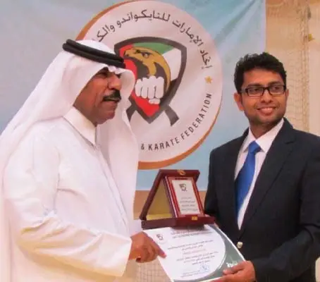 Sensei Ameer Adukkattil receiving memento from the President of UAE Karate Federation